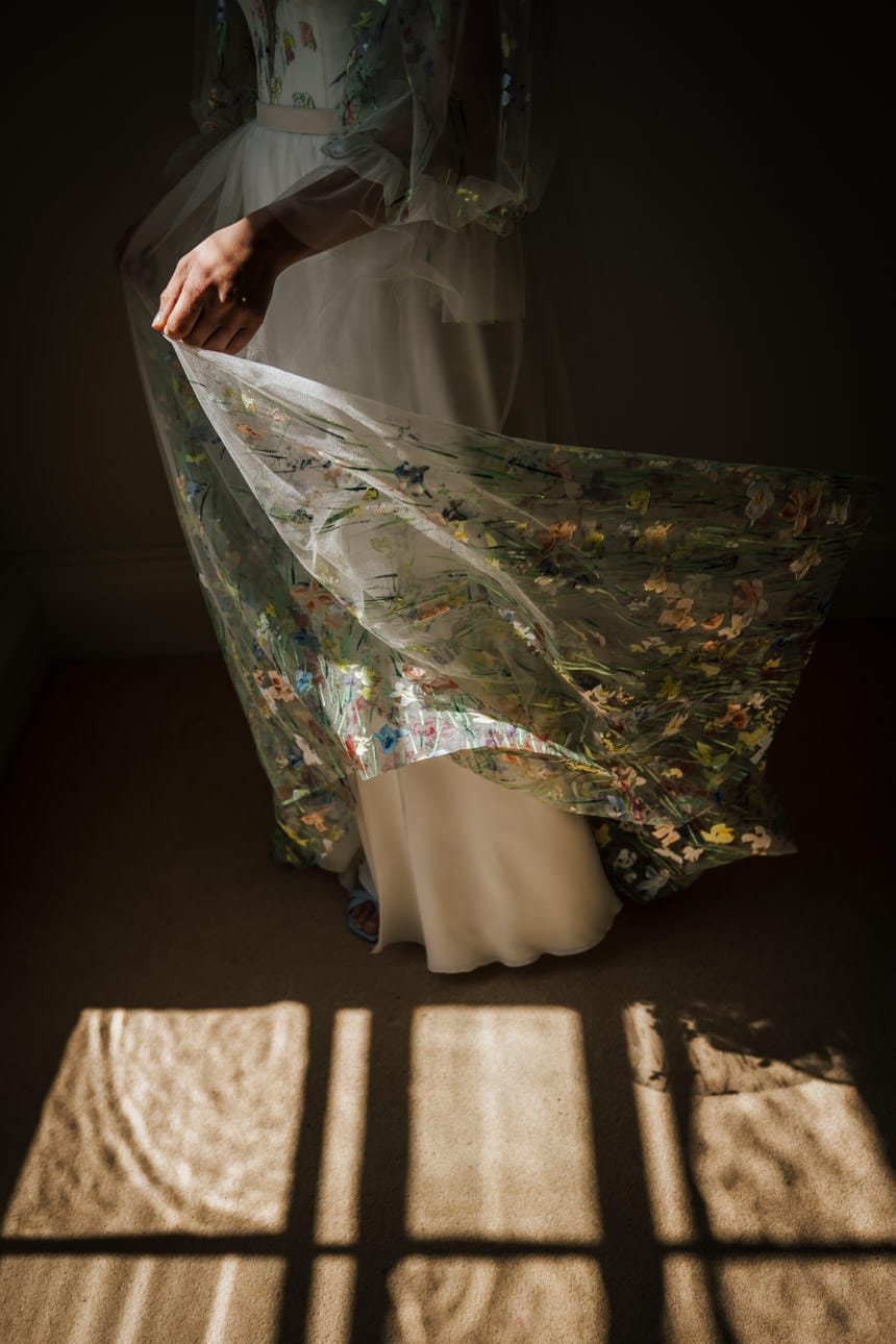 A brides beautiful floral dress catching the sun
