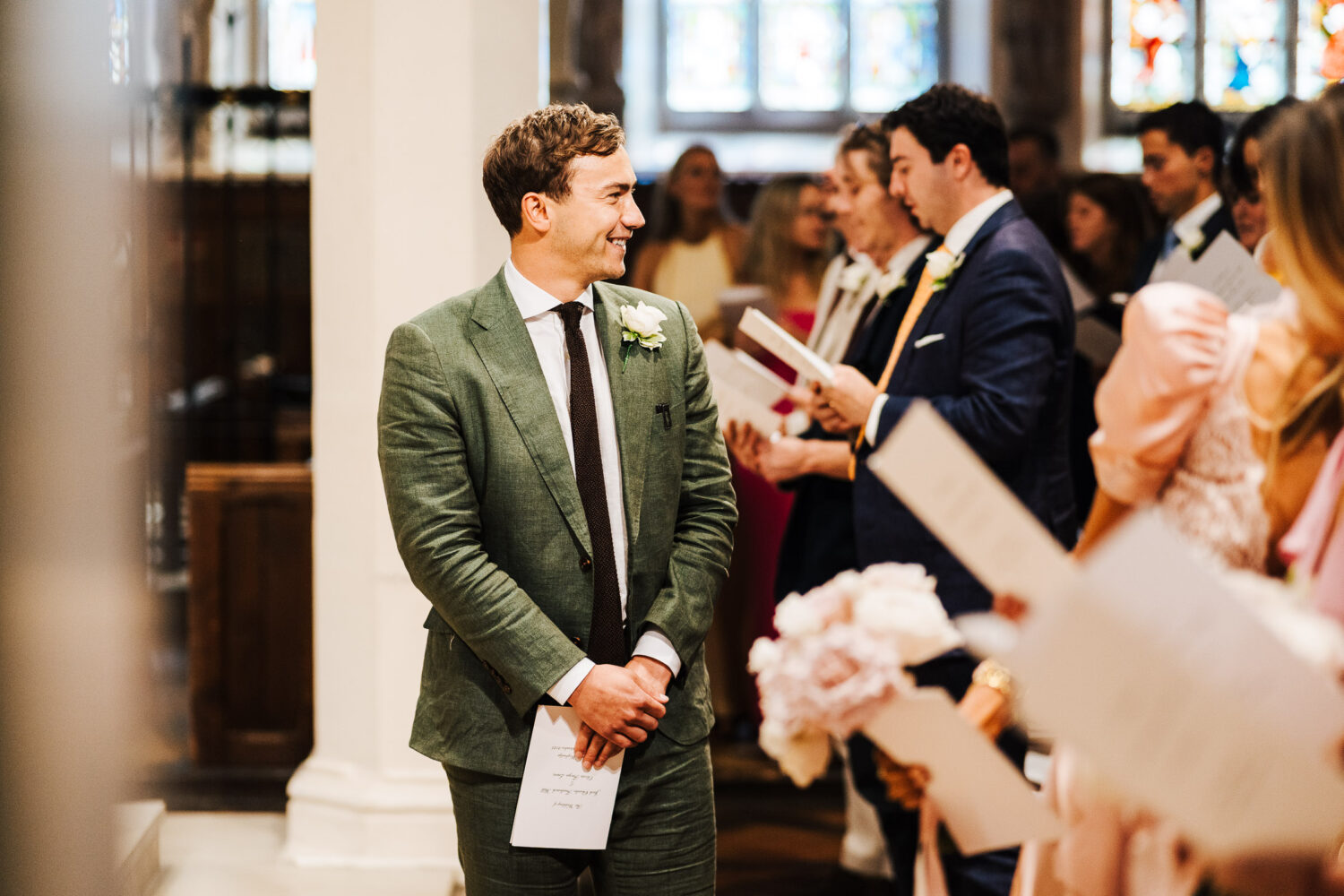 A groom looking at his bride down the aisle