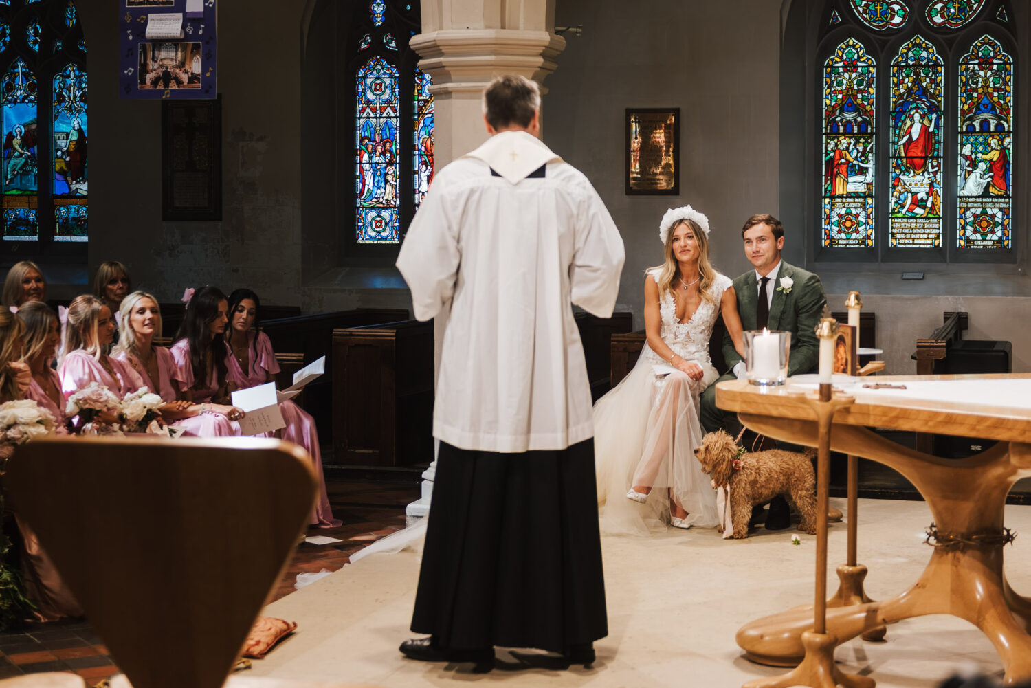 A newly married couple talking to a vicar in church