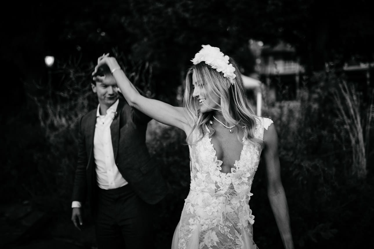 A newly married couple dancing captured in black and white
