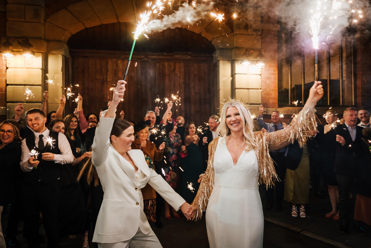 A couple waving fireworks at their wedding