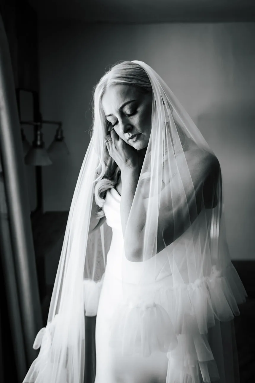 A bride putting on her earings before getting married
