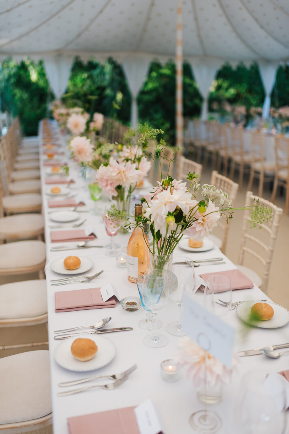 A gorgeous wedding breakfast setup complete with garden flowers and pink champagne