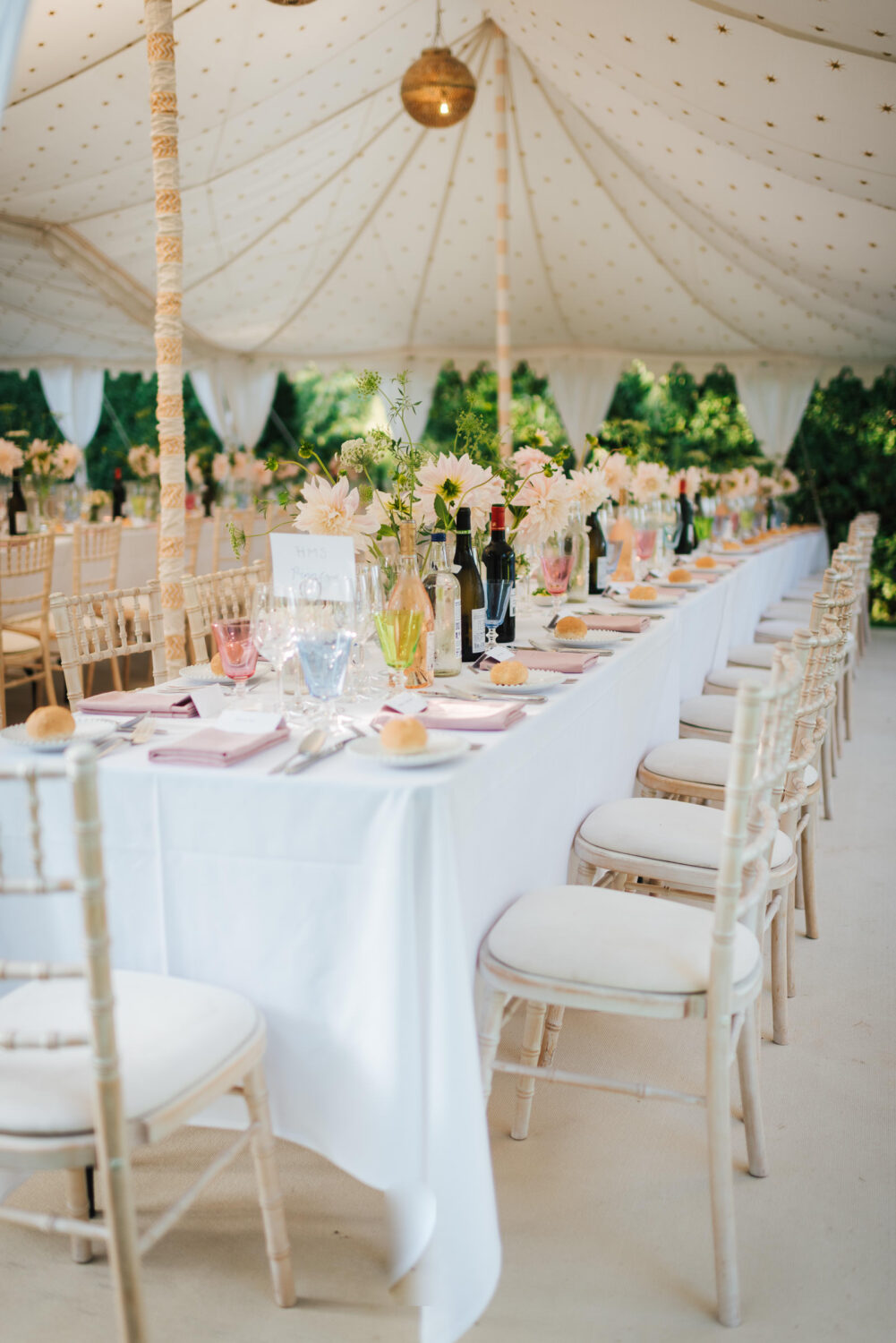 A gorgeous wedding breakfast setup complete with garden flowers and pink champagne
