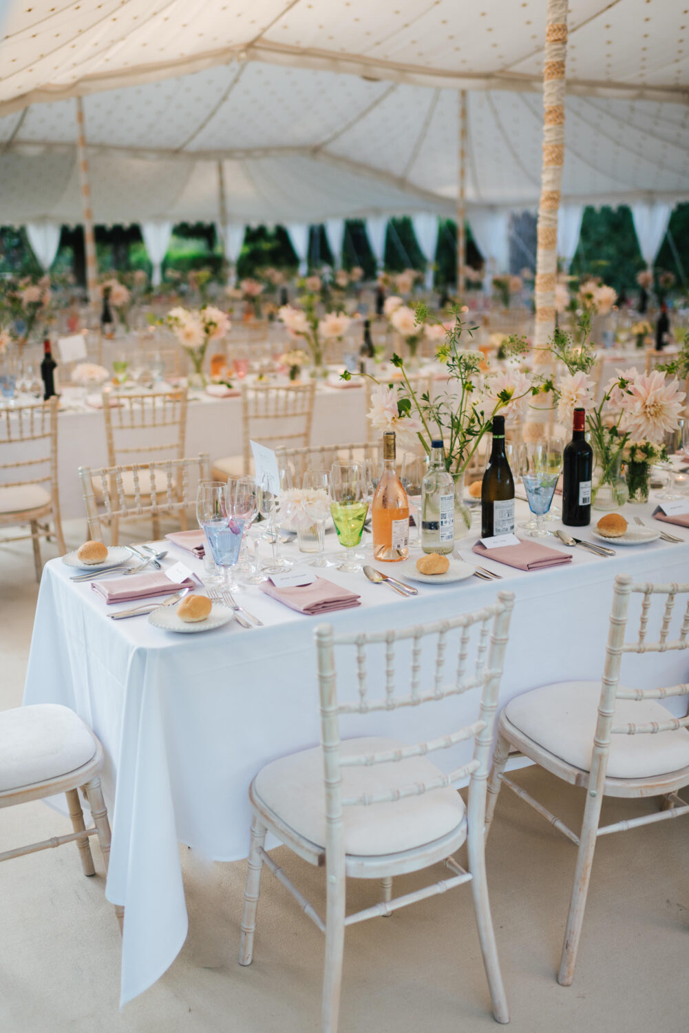 A gorgeous wedding breakfast setup complete with garden flowers and pink champagne