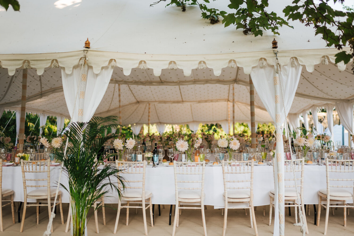 A beautiful luxurious white tent ready for a wedding breakfast with style