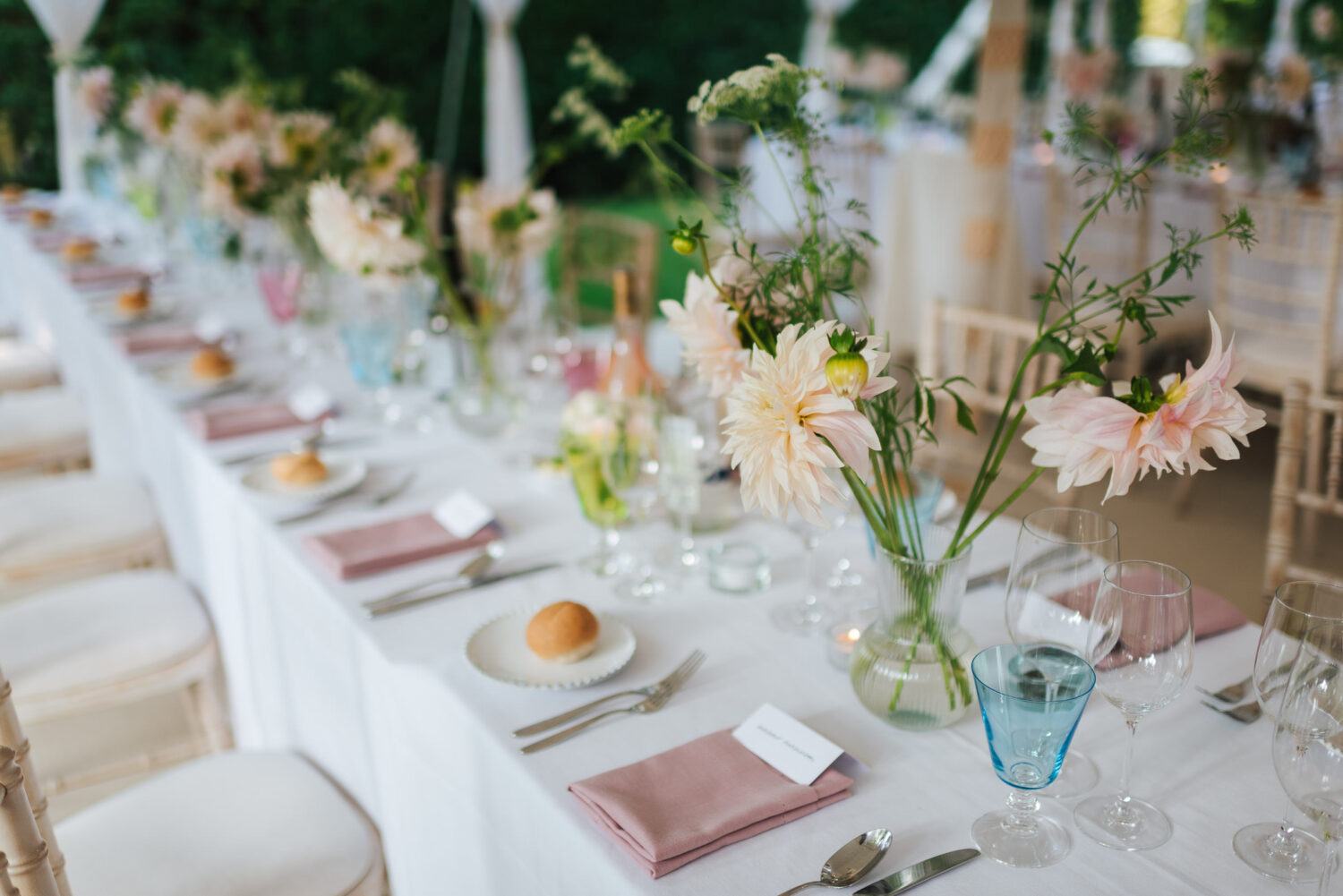 A gorgeous wedding breakfast setup complete with garden flowers and pink champagne