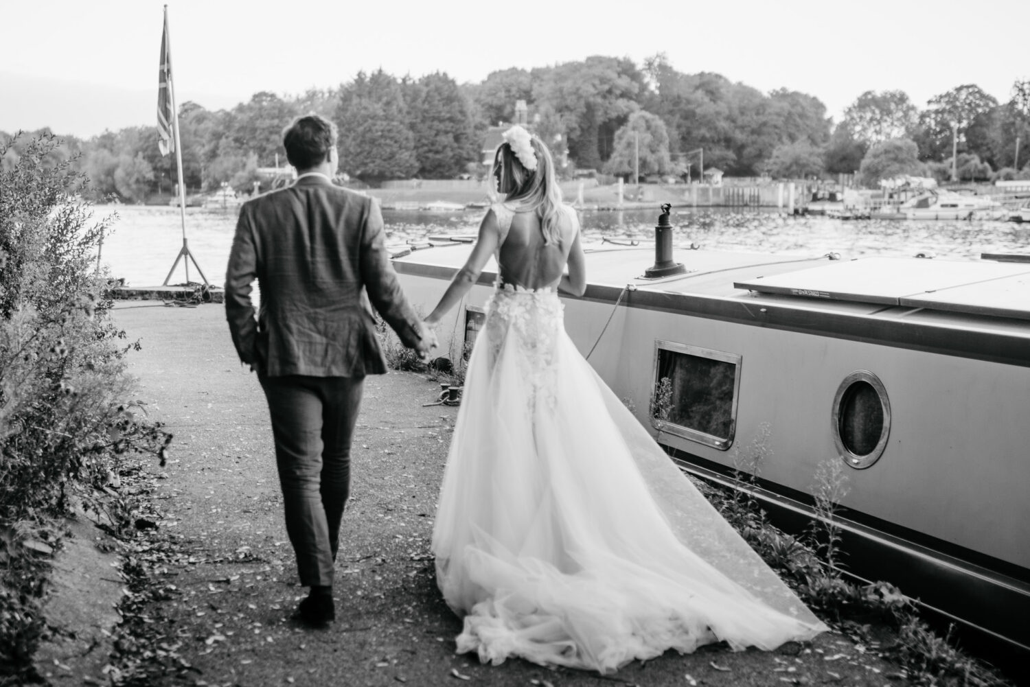 A bride and groom walking along the river thames