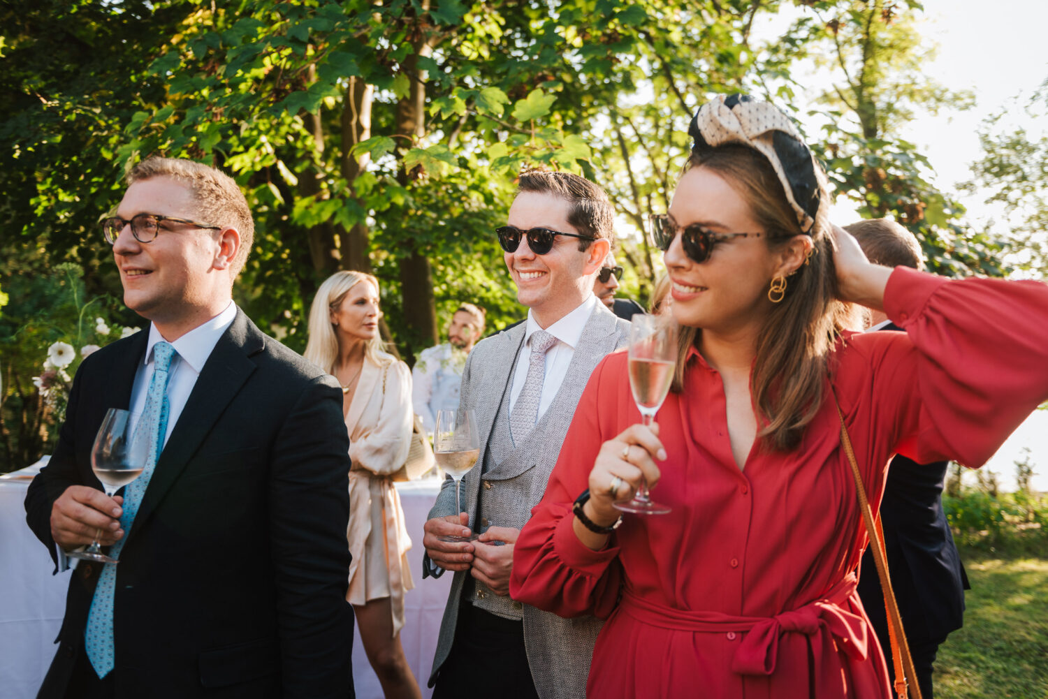 A woman in a red dress listening to wedding speeches